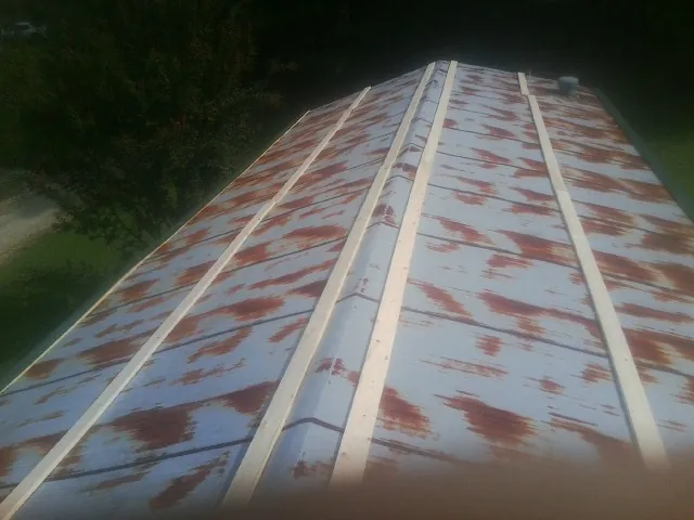 Rusted metal roof panels with new wood purlins before replacement — Storm Damage Roof Repair in Gloucester by Roofing Brothers