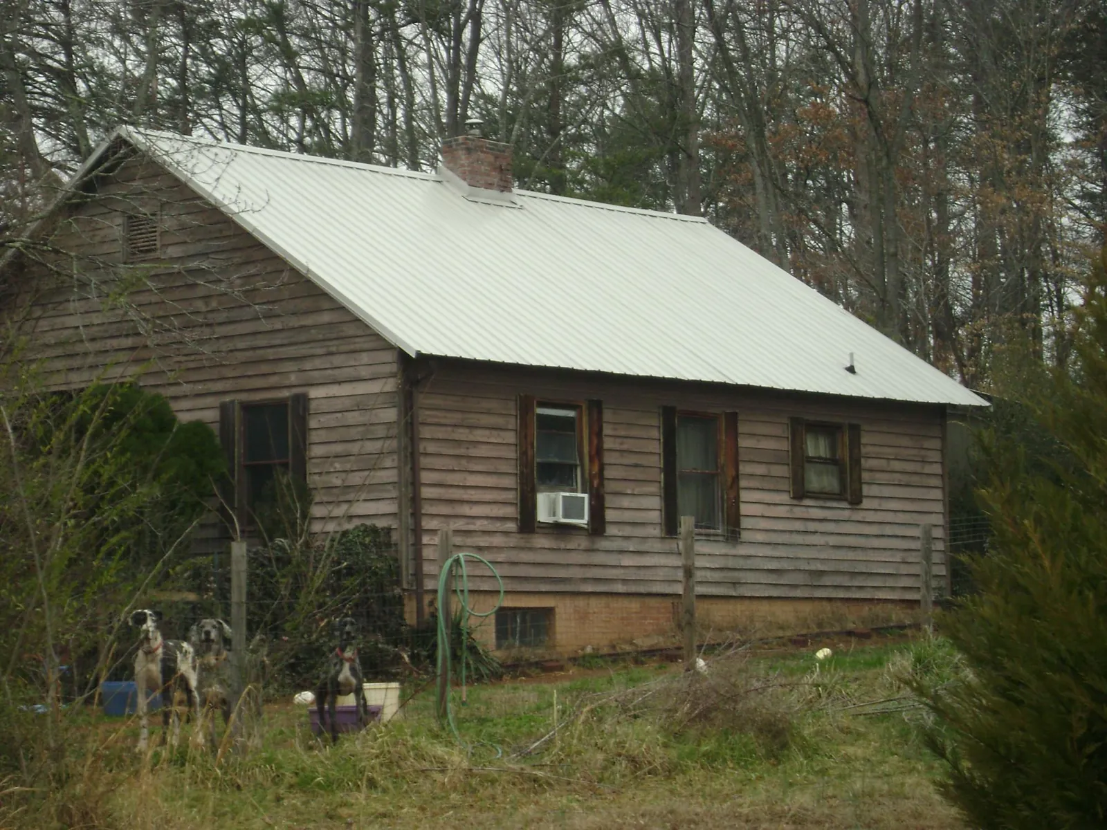 White metal roof on an old wood sided farmhouse, from a Metal Roof Installation job in Gloucester